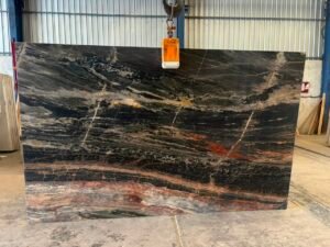 Phoenix Black Quartzite slab held by lifting clamp