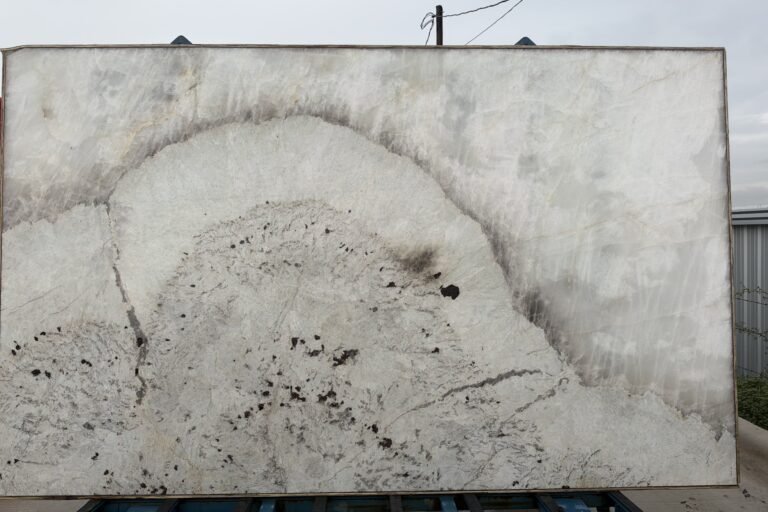White quartzite slab with dramatic natural veining — KJM Stones, Buda TX