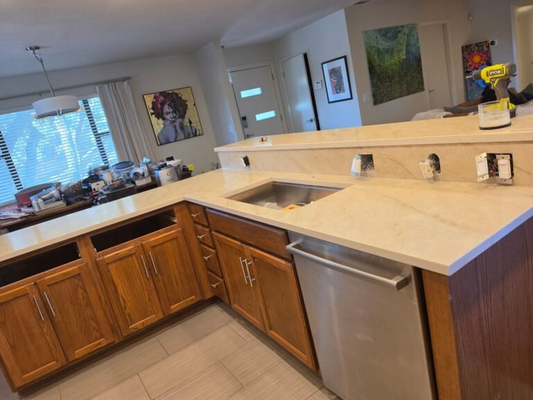 Taj Mahal Quartz countertop, undermount sink and raised bar top on a kitchen peninsula