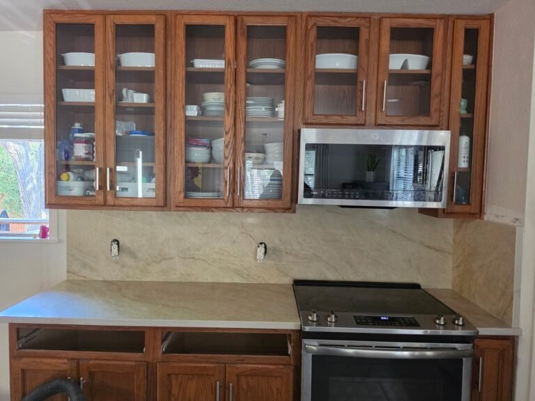Taj Mahal Quartz backsplash and countertop along a kitchen range wall
